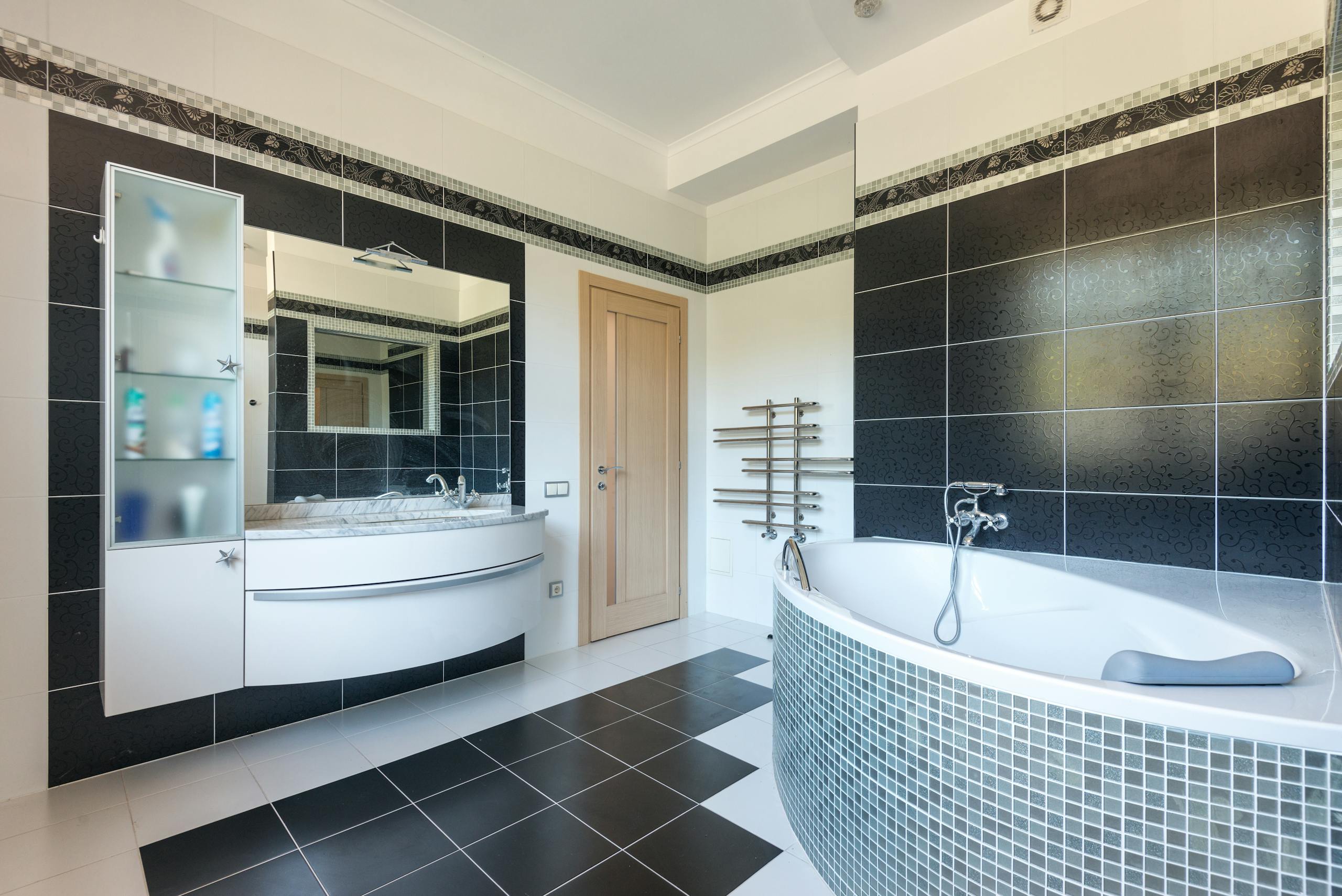 Sleek and modern bathroom interior with elegant black and white tiles.